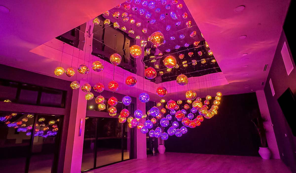Interactive kinetic light sculpture made of illuminated glass spheres, art installation for modern interiors.