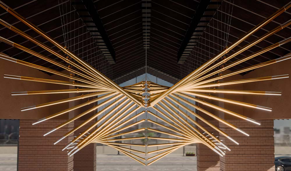 Кинетическая инсталляция "Крылья Долины" из подвесных золотых труб под крышей общественного пространства