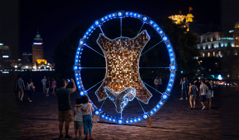 Public art installation “Golden Fleece” in the form of a ram with a golden frame, illuminated by RGB lighting.