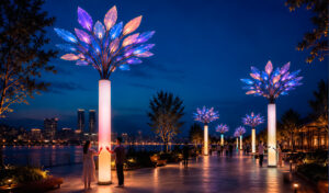 An interactive art installation in the form of a tree on the square along the water in the evening with lighting and people around